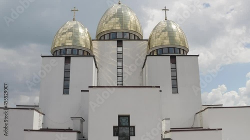 Dome of the church. Aerial view. Traditional old famous church in Ukraine city Lviv, Ukraine. Cloudy sky background. Rizdva Presviatoyi Bohorodytsi Church. 4K UHD drone footage. Copy-space photo