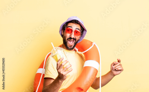 expressive crazy bearded man wearing hat and sun glasses. hollidays concept photo