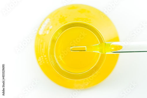 Macro yellow science experiment glass tube,Pipette with liquid biological material. Laboratory concept.