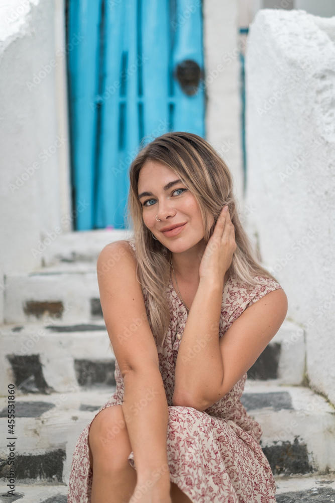 Close-up portrait of pretty caucasian blond girl with attractive blue eyes in casual dress. Sitting outdoors and smiling. Close-up portrait of pretty caucasian blond girl with attractive blue eyes in casual dress. Sitting outdoors and smiling.
