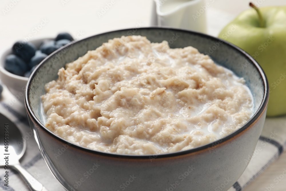 Tasty oatmeal porridge served on table, closeup Tasty oatmeal porridge served on table, closeup