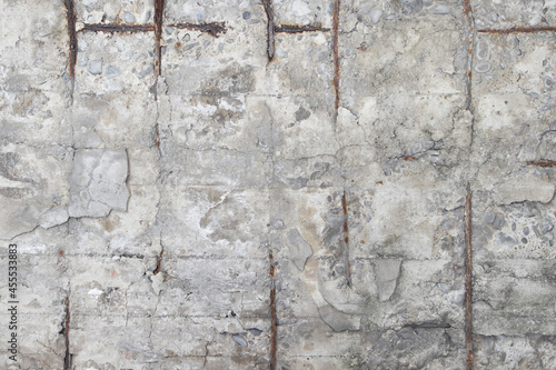Texture of old gray concrete wall for background.Texture detail of metal revealed on concrete wall.Stone wall background. Concrete texture.