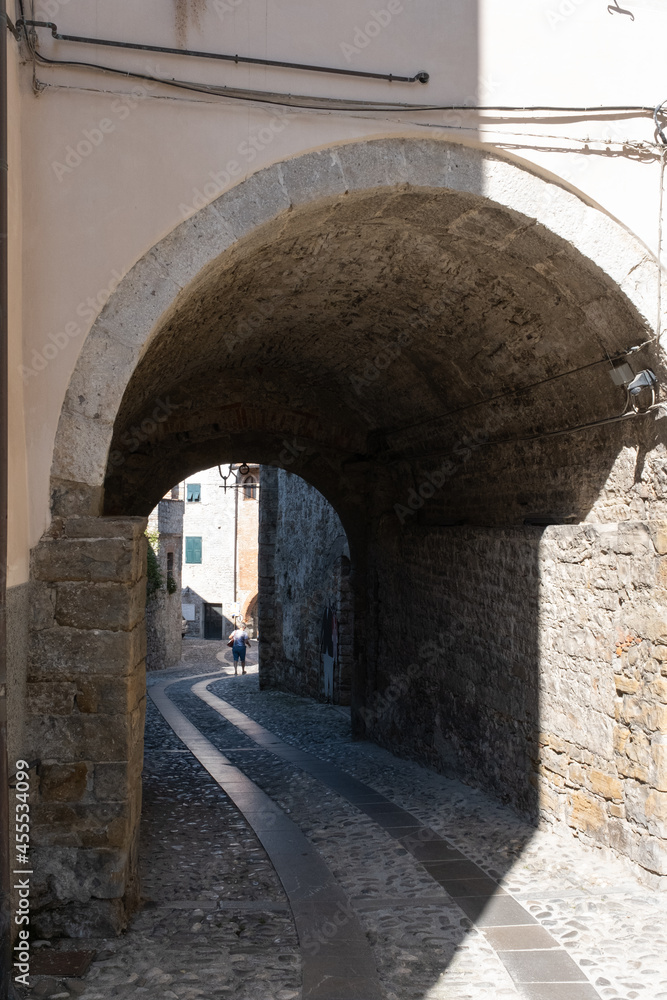 Obraz premium Cividale del Friuli (Udine), Italy - September 5, 2021: North Italy Life in the center of the lombard medieval city. Walking through narrow streets and walls. Sunny summer day. Selective focus