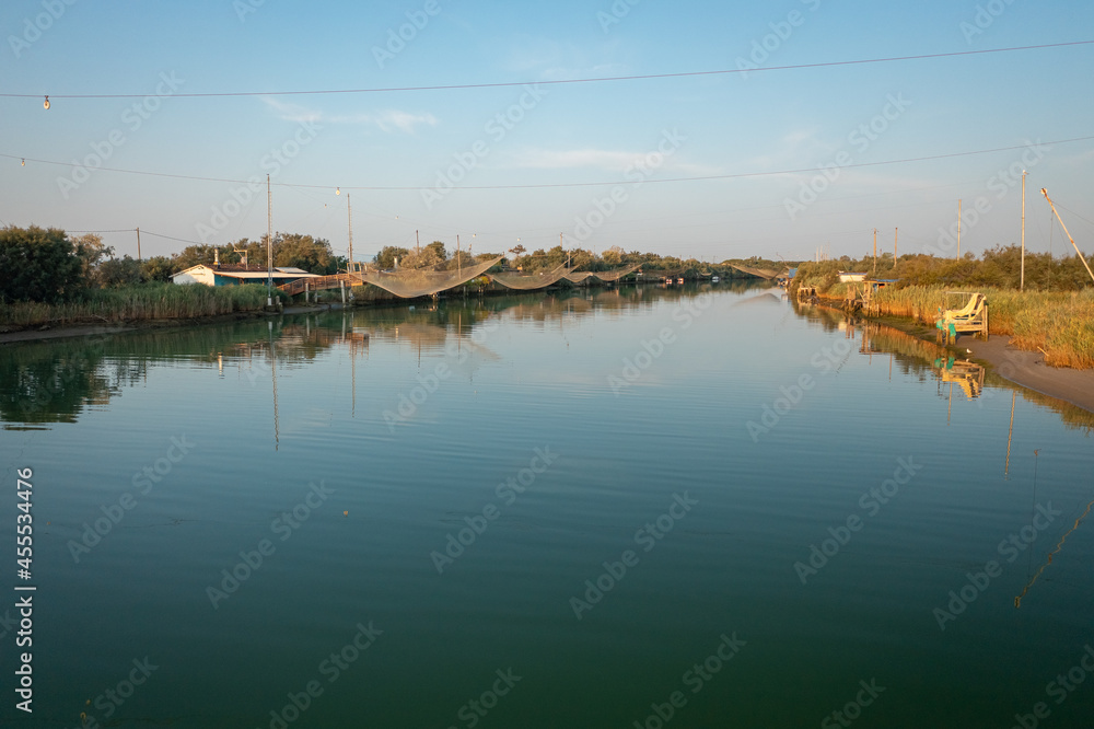 Landscape view of fishing huts on river with typical italian fishing machine, called 