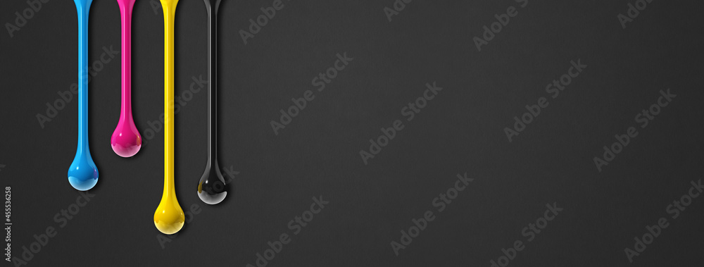 cmyk ink drops on black paper banner background cmyk ink drops on black paper banner background