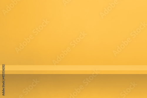 Fototapeta Naklejka Na Ścianę i Meble -  Empty shelf on a yellow wall. Background template. Horizontal backdrop