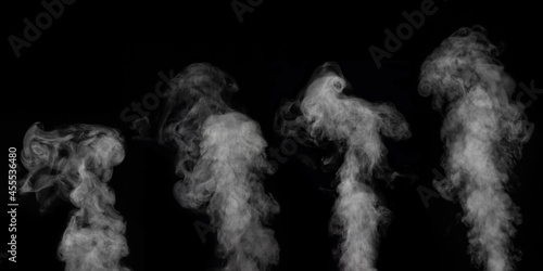 A perfect set of four different mystical curly white vapors or smoke on a black background. Abstract fog for halloween.
