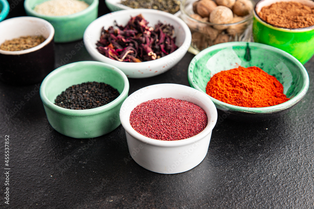 spices and herbs for cooking. Sumac, pepper, paprika, rosemary, khmelisuneli, cloves and more fresh portion ready to eat meal snack on the table copy space food background rustic. top view spices and herbs for cooking. Sumac, pepper, paprika, rosemary, khmelisuneli, cloves and more fresh portion ready to eat meal snack on the table copy space food background rustic. top view