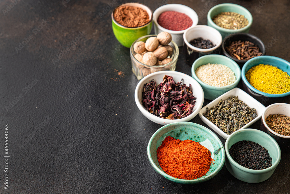 spices and herbs for cooking. Sumac, pepper, paprika, rosemary, khmelisuneli, cloves and more fresh portion ready to eat meal snack on the table copy space food background rustic. top view spices and herbs for cooking. Sumac, pepper, paprika, rosemary, khmelisuneli, cloves and more fresh portion ready to eat meal snack on the table copy space food background rustic. top view