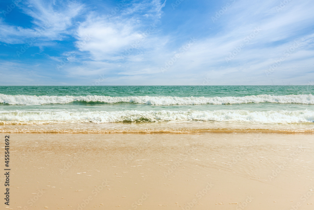 Tropical beach Natural background for summer vacation. Turquoise ocean water and blue sky with clouds in sunny day. Beautiful beach with white sand. Tropical beach Natural background for summer vacation. Turquoise ocean water and blue sky with clouds in sunny day. Beautiful beach with white sand.