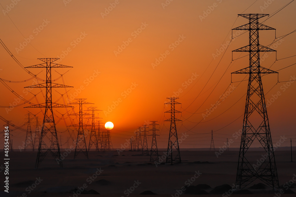 Highvoltage power lines in Saudi Arabia (KSA) at sunset or sunrise