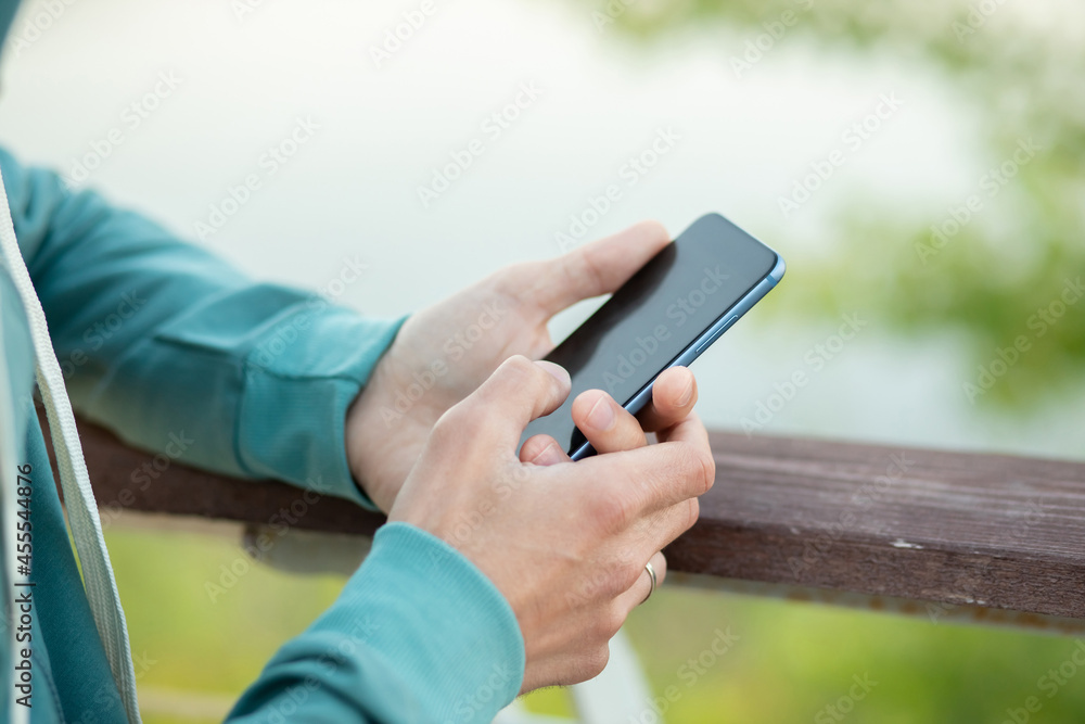 Man using smart phone outdoors Man using smart phone outdoors