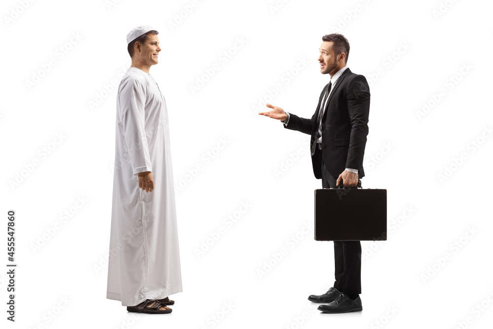 Full length profile shot of a young arab man having a conversation with a businessman with a briefcase Full length profile shot of a young arab man having a conversation with a businessman with a briefcase