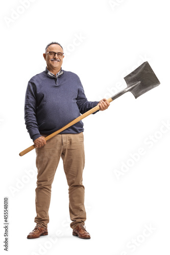 Mature smiling man in casual clothes holding a shovel