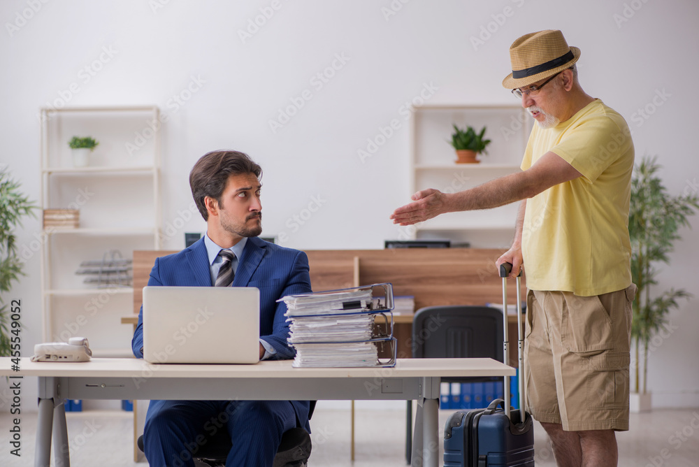 Old boss and young male employee in summer vacation concept Old boss and young male employee in summer vacation concept