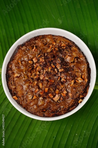 Kalthappam or Kalathappam- Malabar special Steamed sweet rice cake with shallots jaggery and dry coconut chunks photo