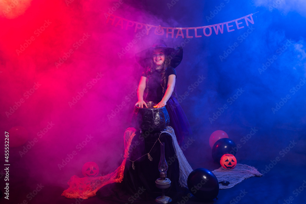 Funny child girl in witch costume for Halloween with pumpkin Jack. Funny child girl in witch costume for Halloween with pumpkin Jack.