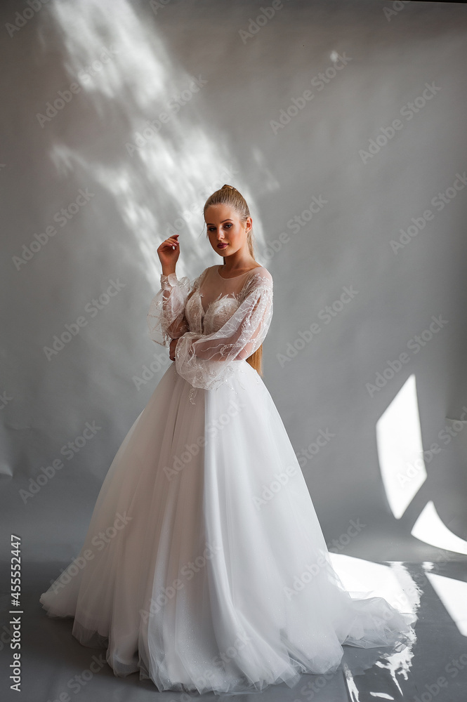 Perfect bride, portrait of a girl in a long white dress. Beautiful hair and clean delicate skin. Wedding hairstyle blonde woman. Perfect bride, portrait of a girl in a long white dress. Beautiful hair and clean delicate skin. Wedding hairstyle blonde woman.