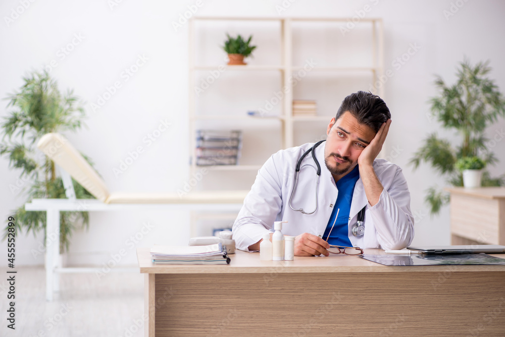 Young male doctor working in the clinic Young male doctor working in the clinic
