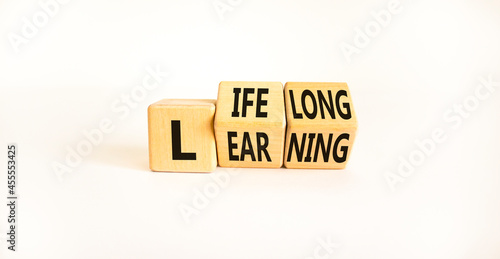 Lifelong learning symbol. Turned wooden cubes with concept words 'Lifelong learning' on a beautiful white background. Copy space. Business, educational and lifelong learning concept. photo