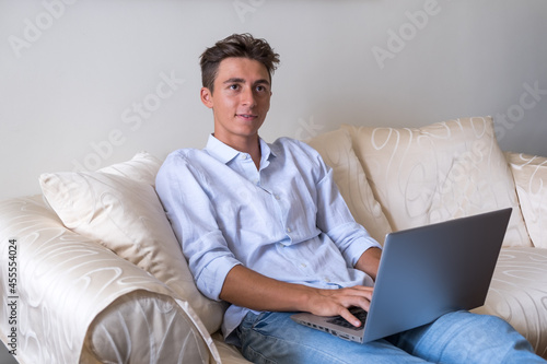 Young man with laptop in smart working with college classes and lessons - young people with technology - modern lifestyle with online courses and school stock photo