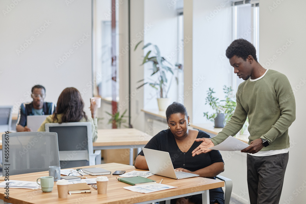 Young Black businessman criticizing product presentation created by his colleague Young Black businessman criticizing product presentation created by his colleague