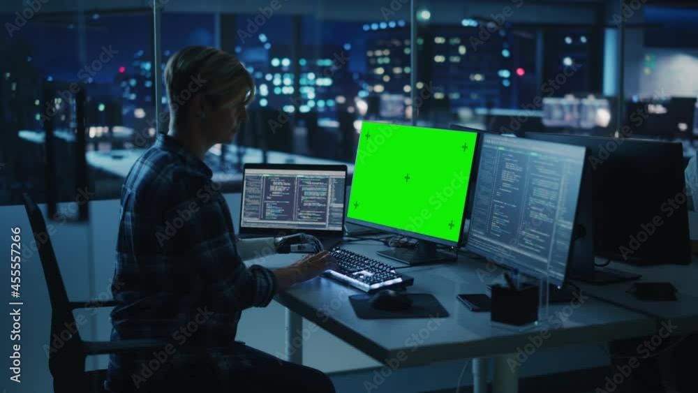 Diverse Teamwork in Office at Night: Person with Disability Using Prosthetic Arm to Work on Green Screen Chroma Key Computer. Team of Software Engineers work Late to create Innovative App Diverse Teamwork in Office at Night: Person with Disability Using Prosthetic Arm to Work on Green Screen Chroma Key Computer. Team of Software Engineers work Late to create Innovative App