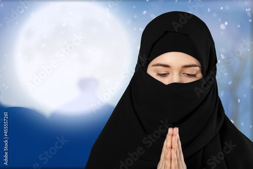 Muslim woman praying with the night scene background