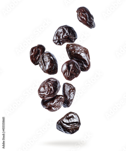 Delicious prunes in the air isolated on white background