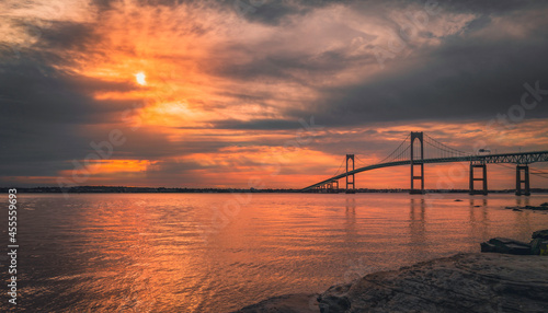 Dramatic cloudscape at sunrise over Claiborne Pell Newport Bridge on Route 138 in Rhode Island © Naya Na