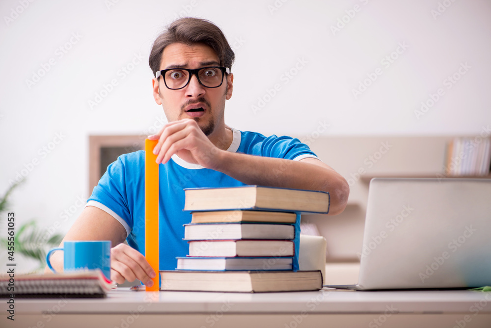 Young male student studying at home Young male student studying at home