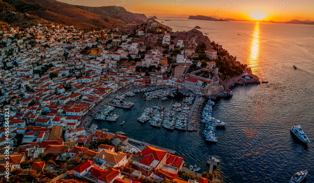 Aerial drone panoramic photo of the picturesque port and main village of Hydra (or Ydra) island at sunset. Hydra is a top tourist destination with neoclassic houses located in Saronic gulf, Greece.