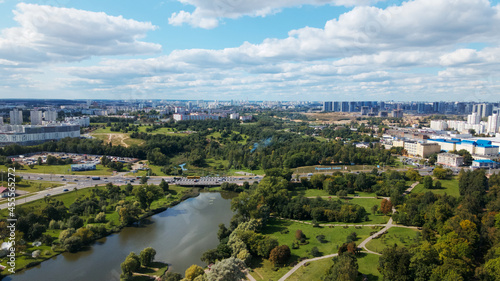 City landscape. Nearby there is a park area. Blue sky with white clouds. Aerial photography. © f2014vad