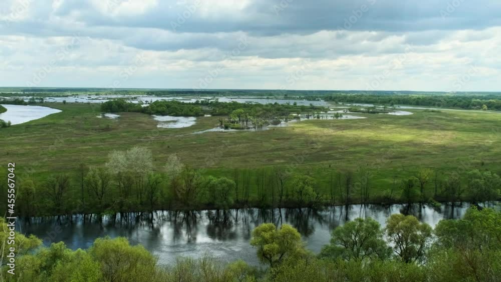 View of a summer landscape and summer cloudy skies. Panorama clip of cloudy summer sky. Panning video of countryside during a cloudy summer day.
