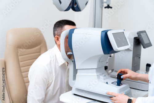 Professional medical equipment scanning patient glasses. Modern clinic healthcare device. Vision and medicine concept