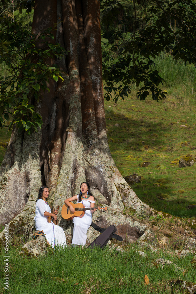 indigenous women with instruments singing in nature. Make music outdoors. Free lifestyle. indigenous peoples of the world.