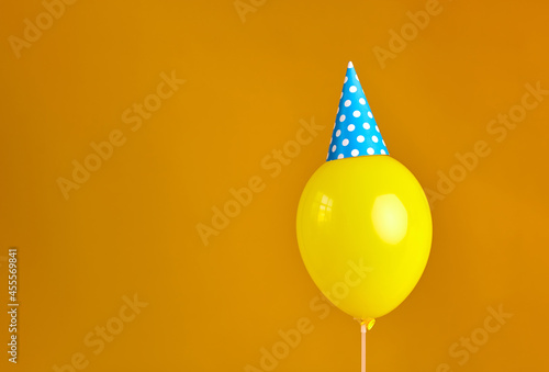 Photography Birthday party balloon with party hat against orange background