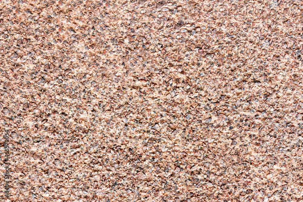 The mottled surface of the granite slab is finely speckled. Uniform texture of natural stone. The mottled surface of the granite slab is finely speckled. Uniform texture of natural stone.