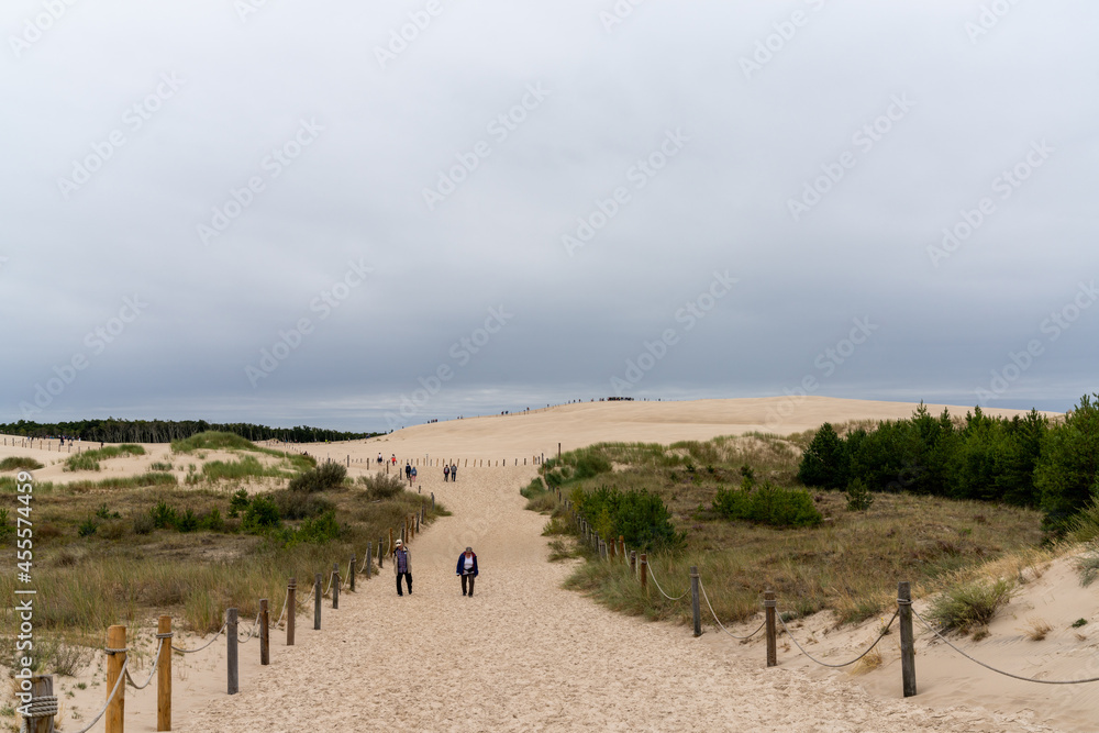 tourists enjoy a visit to the sand dunes of Slowinksi National Park in northern Poland tourists enjoy a visit to the sand dunes of Slowinksi National Park in northern Poland