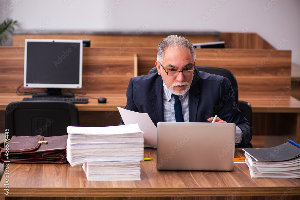 Old male employee and too much work in the office Old male employee and too much work in the office