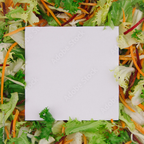 White square shaped paper note with border of fresh diet salad