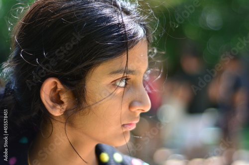 Close-up profile of young Indian girl in daylight photo