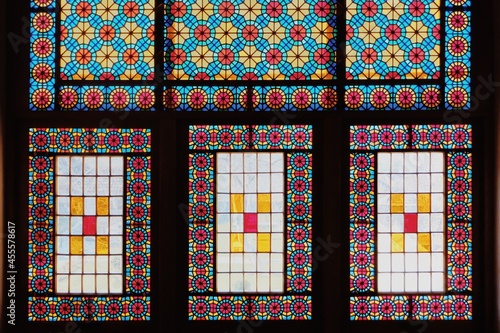Colorful geometrical and floral patterned stained windows photo