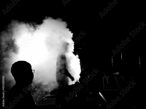 Grayscale photo of two men surrounded by smoke photo