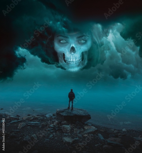 Illustration of man standing on the rock at seashore looking at Human skull in stormy sky photo