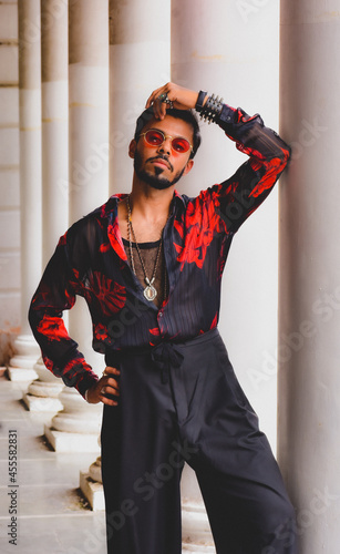 Man wears blue and red overall