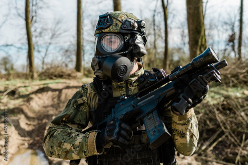 Multiple valuArmed soldier in Cropat pattern uniform wearing M95 Gas mask and assault rifle HK G36.es