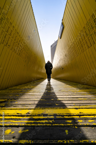 Person walking on yellow wooden pathway photo