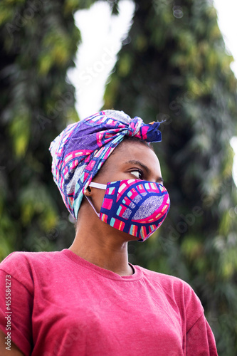 Portrait of a woman in a colorful face mask outdoors photo