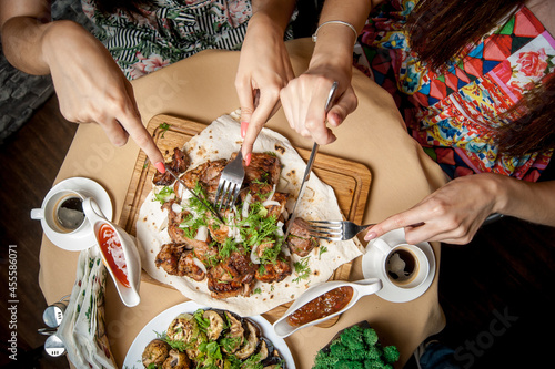Wallpaper Mural Top view of two women eating dinner Torontodigital.ca